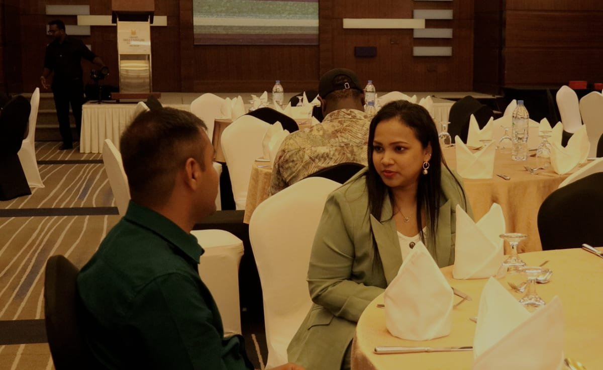 A mentor speaking with a student at a Stewarts Academy event
