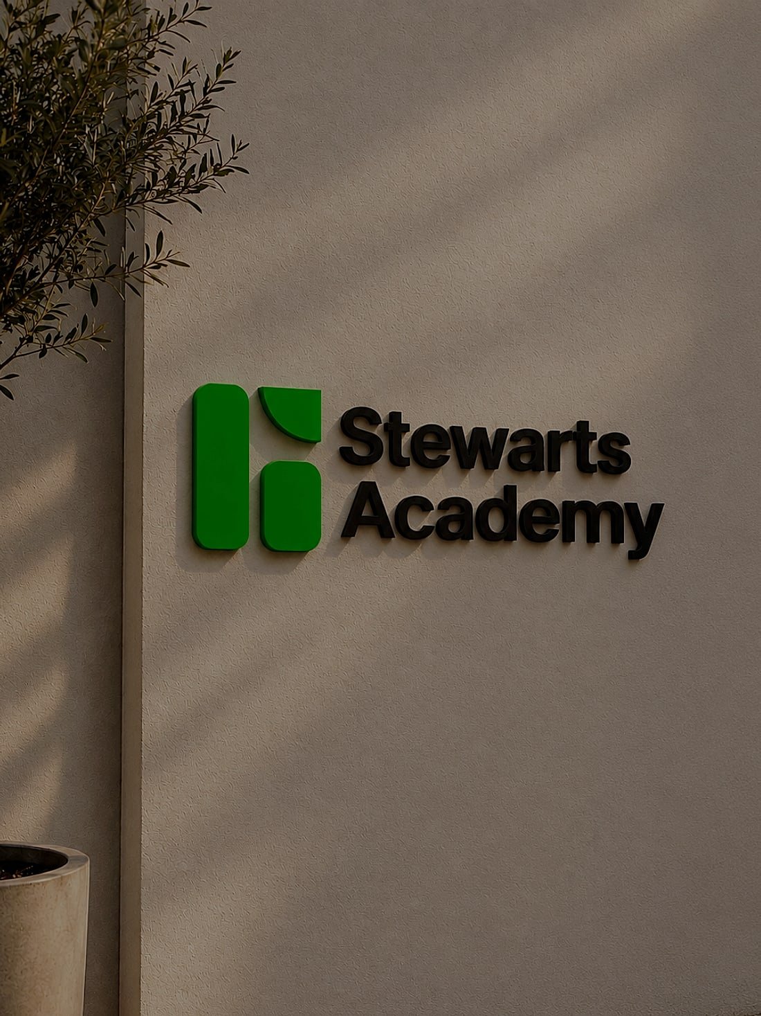 Stewarts Academy sign on a wall